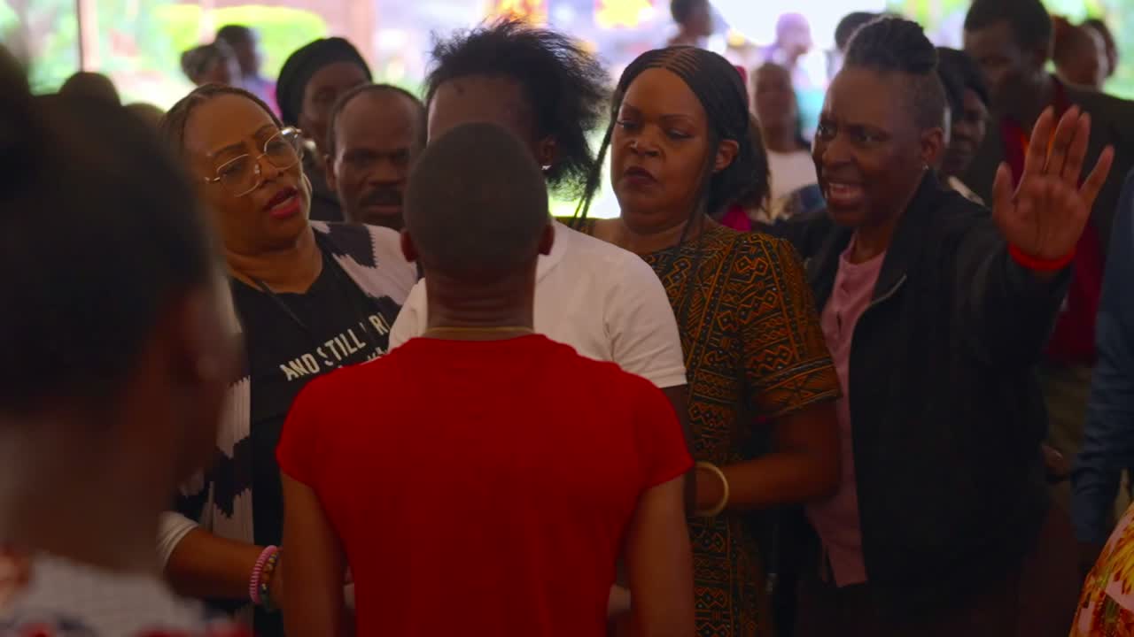 Members of the delegation praying with the local community in Kenya